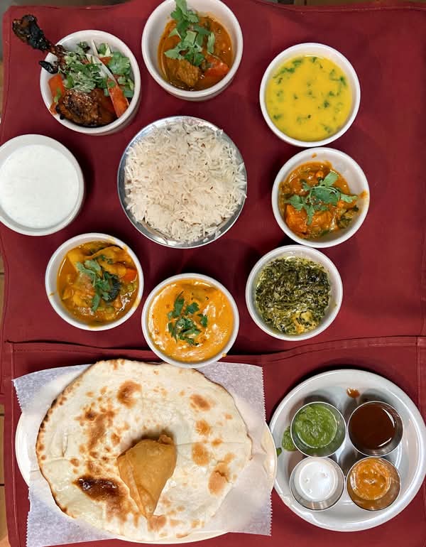 A Karma Kitchen thali sampler: rice, dal, chicken tikka, curries, chutneys, naan and samosa