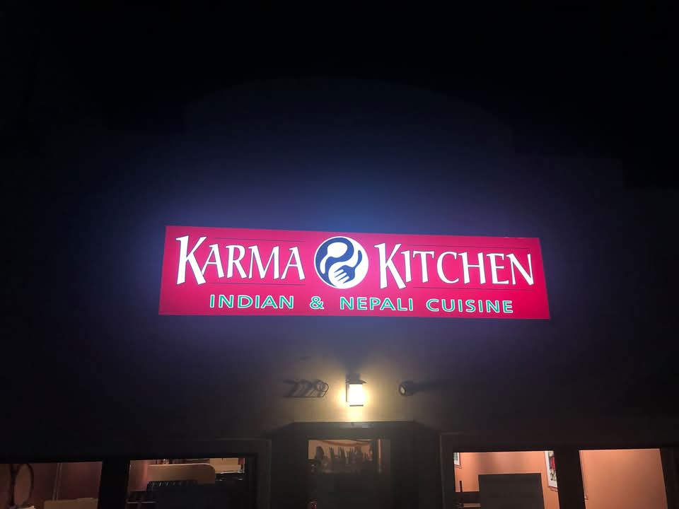 Karma Kitchen's illuminated storefront sign, 229 E Aspen Ave, Fruita